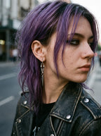Woman with purple hair wearing Razor Fang Spike Earrings and a black leather jacket
