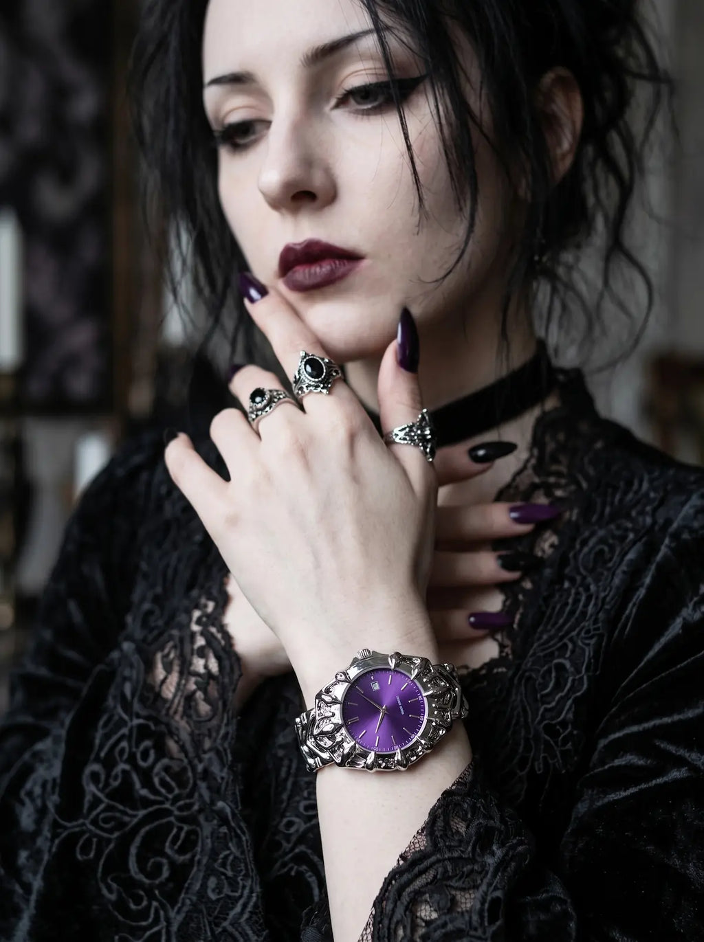 Razorclaw Gothic Watch, purple-dial watch on a model's wrist with black lace sleeves and silver rings