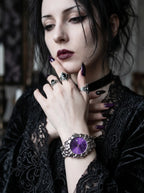 Razorclaw Gothic Watch, purple-dial watch on a model's wrist with black lace sleeves and silver rings