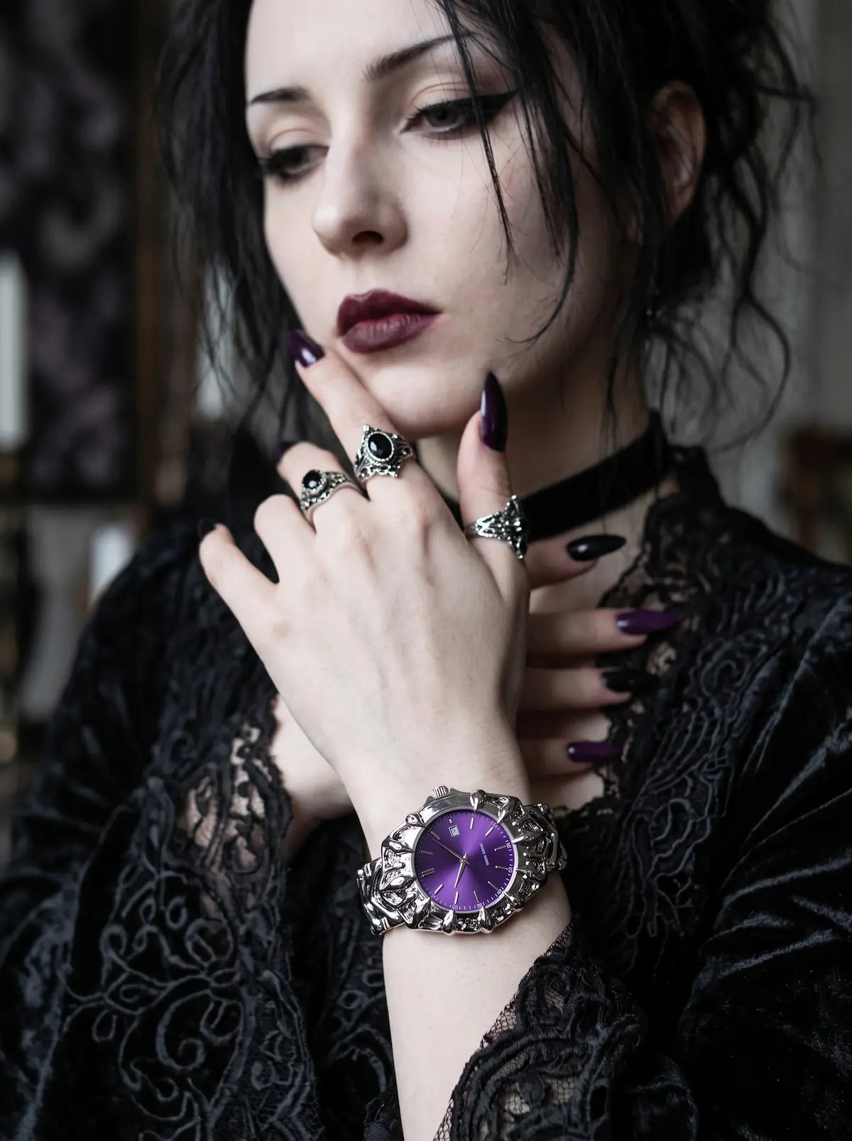 Razorclaw Gothic Watch, purple-dial watch on a model's wrist with black lace sleeves and silver rings