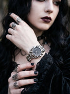 Razorclaw Gothic Watch, silver-dial watch worn with dark clothing and silver rings, close wrist detail