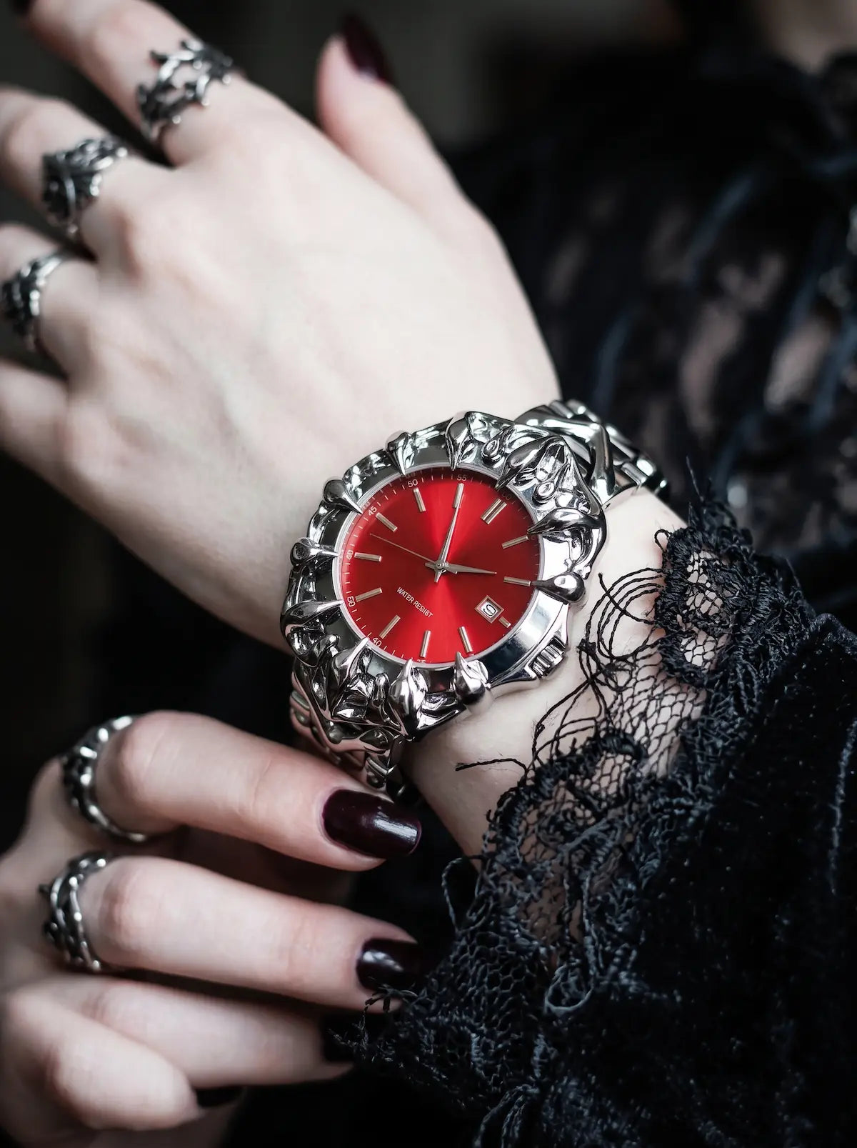 Razorclaw Gothic Watch, red-dial watch displayed on a wrist with black lace and silver rings