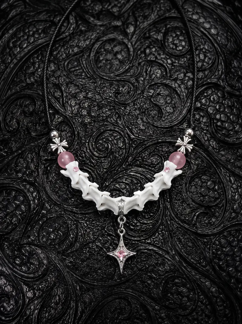 Roselight Snake Bone Necklace, white snake bone necklace with pink bead accents and a pointed star pendant