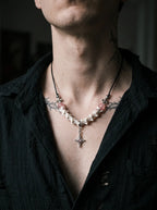 Roselight Snake Bone Necklace, close neck view of pink accent beads and silver-tone pointed pendant