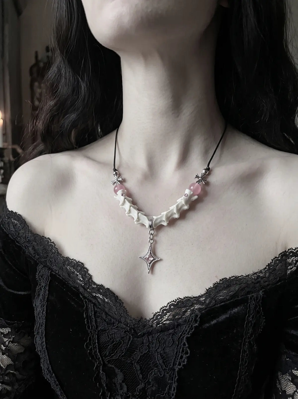 Roselight Snake Bone Necklace, front view of pink accented snake bone necklace and dangling pointed star