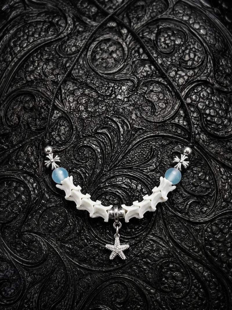 Seafoam Starfish Snake Bone Necklace, white vertebrae necklace with light blue beads and a dangling starfish charm