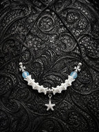Seafoam Starfish Snake Bone Necklace, white vertebrae necklace with light blue beads and a dangling starfish charm