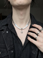 Seafoam Starfish Snake Bone Necklace, white vertebrae and starfish necklace seen on a model in a dark jacket
