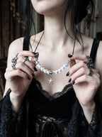 Seafoam Starfish Snake Bone Necklace, close front view of light blue beads and silver-tone starfish charm held in hands