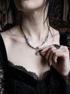 Seafoam Starfish Snake Bone Necklace, seafoam-blue and bone necklace worn at the collarbone over a black top
