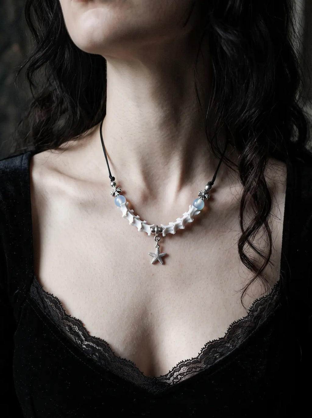 Seafoam Starfish Snake Bone Necklace, pale bone necklace with blue beads and tiny starfish pendant on a lace neckline