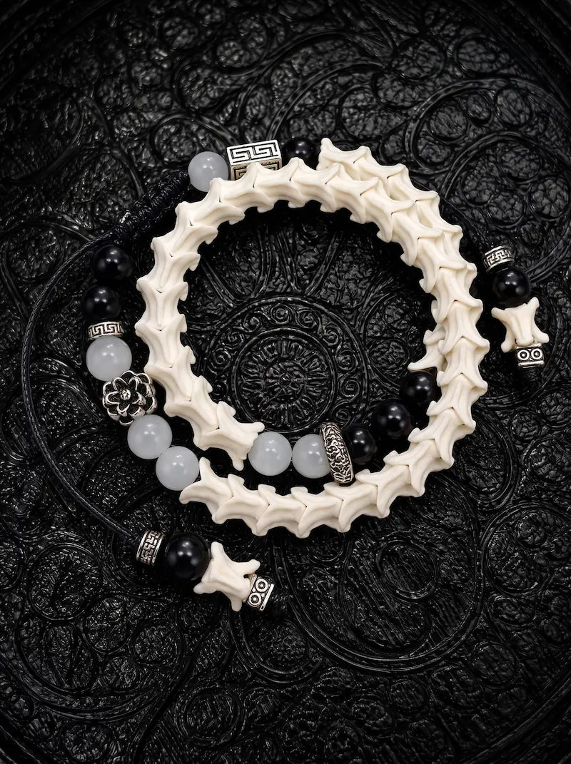 Smoky Rosette double-wrap snake bone bracelet with black and gray beads, a silver-tone flower and black cords