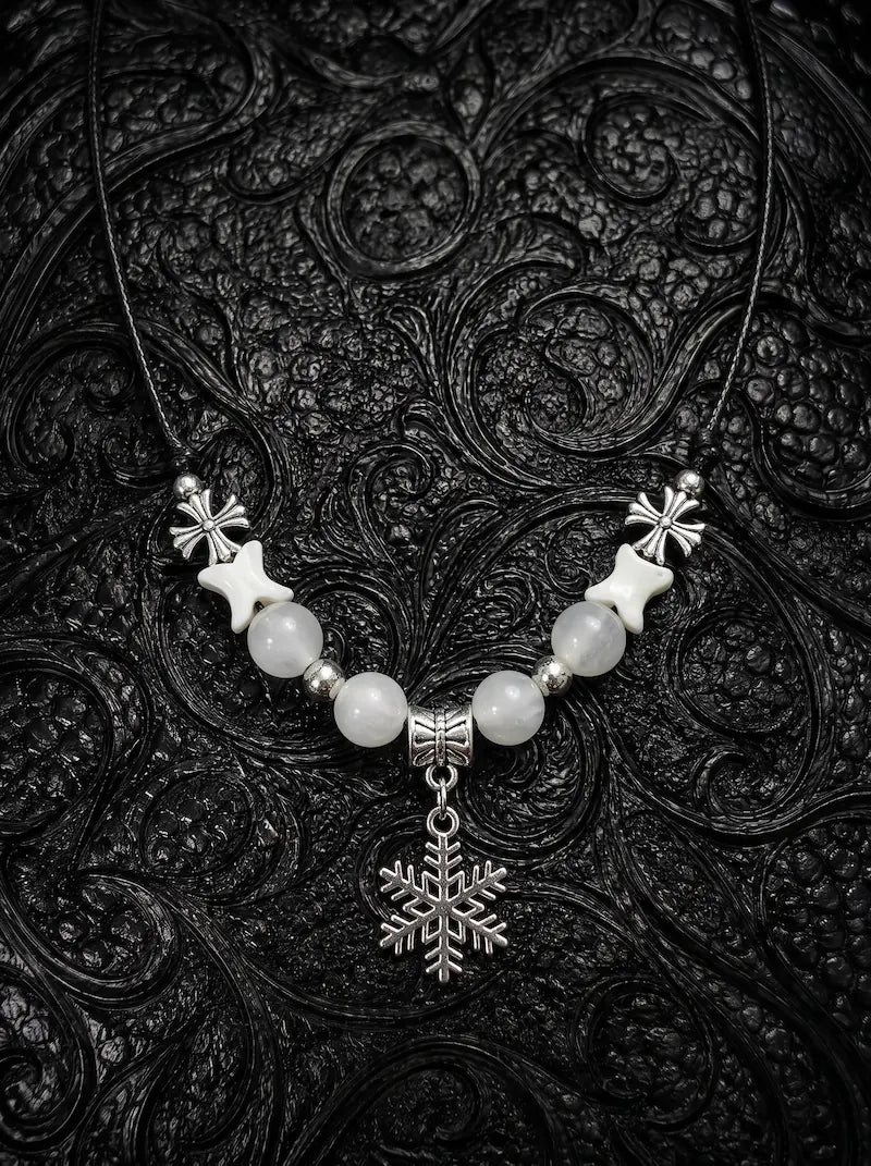 Snowbound Snake Bone Necklace, pale vertebrae necklace with white beads and a detailed snowflake pendant