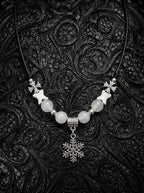 Snowbound Snake Bone Necklace, pale vertebrae necklace with white beads and a detailed snowflake pendant