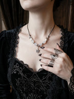 Snowbound Snake Bone Necklace, close neck view of the pale vertebrae and snowflake necklace with silver rings