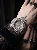 Solar Sigil Gothic Watch, silver engraved watch on a tattooed wrist beside black lace fabric