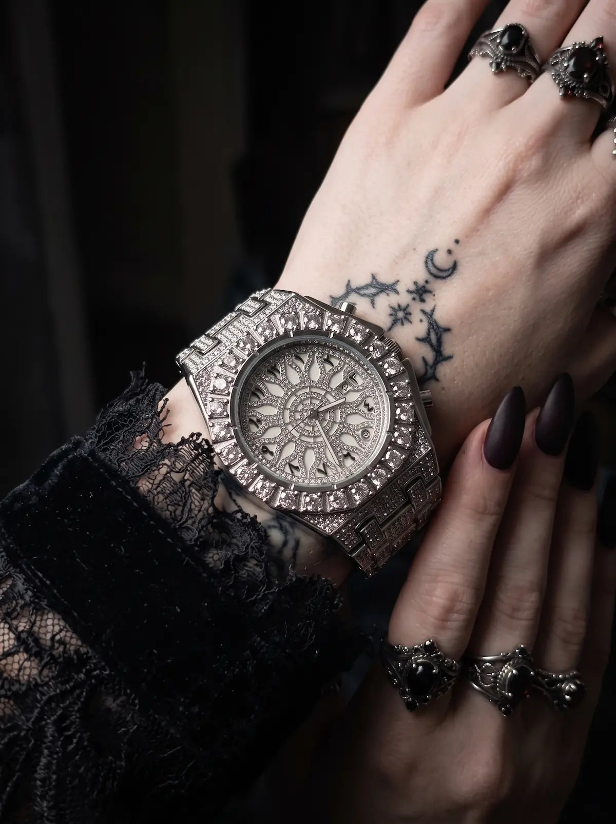 Solar Sigil Gothic Watch, silver engraved watch on a tattooed wrist beside black lace fabric