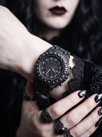Solar Sigil Gothic Watch, black Solar Sigil watch displayed on a wrist with dark rings and lace