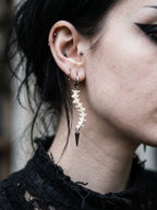 Spinepoint Snake Bone Earrings, long snake bone earring worn from the side with dark spear-shaped tip