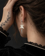 Short-spike Spire Chain snake bone earring viewed from behind with the hair held up