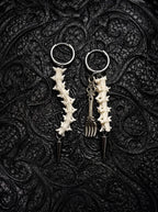 Split Relic Snake Bone Earrings, matching pale vertebrae earrings with assorted dark silver-tone drop ornaments