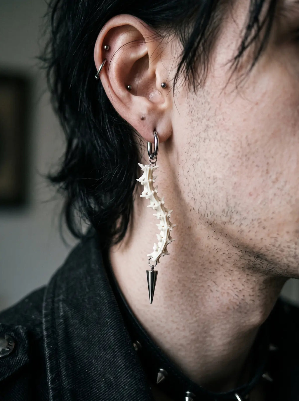 Split Relic Snake Bone Earrings, side profile featuring long pale snake bone earring with a pointed pendant