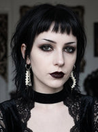 Split Relic Snake Bone Earrings, portrait showing paired vertebrae earrings of different ornate metal accents