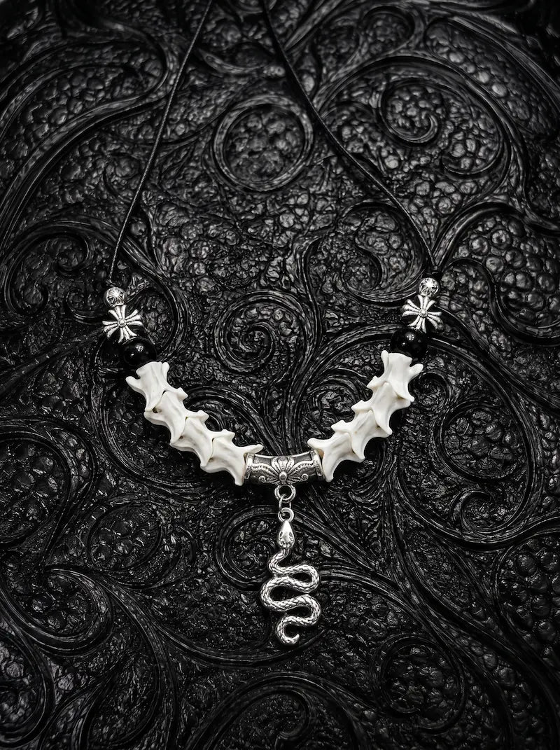 Vesper Serpent Snake Bone Necklace, curved pale snake vertebrae necklace with silver-tone coiled serpent pendant