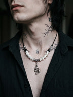 Vesper Serpent Snake Bone Necklace, snake vertebrae necklace with silver snake pendant worn above a black shirt
