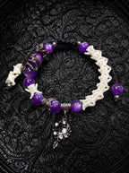 Violet Dragon snake bone bracelet with purple beads, a sculpted dragon accent and an ornate crescent charm on black cords