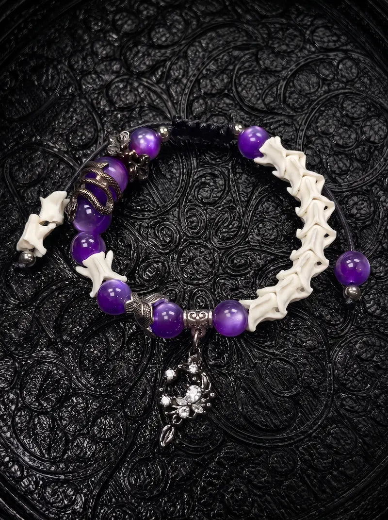 Violet Dragon snake bone bracelet with purple beads, a sculpted dragon accent and an ornate crescent charm on black cords