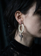 Side view of a Viper Drop snake bone hoop earring showing its coiled snake and spike beneath the hoop