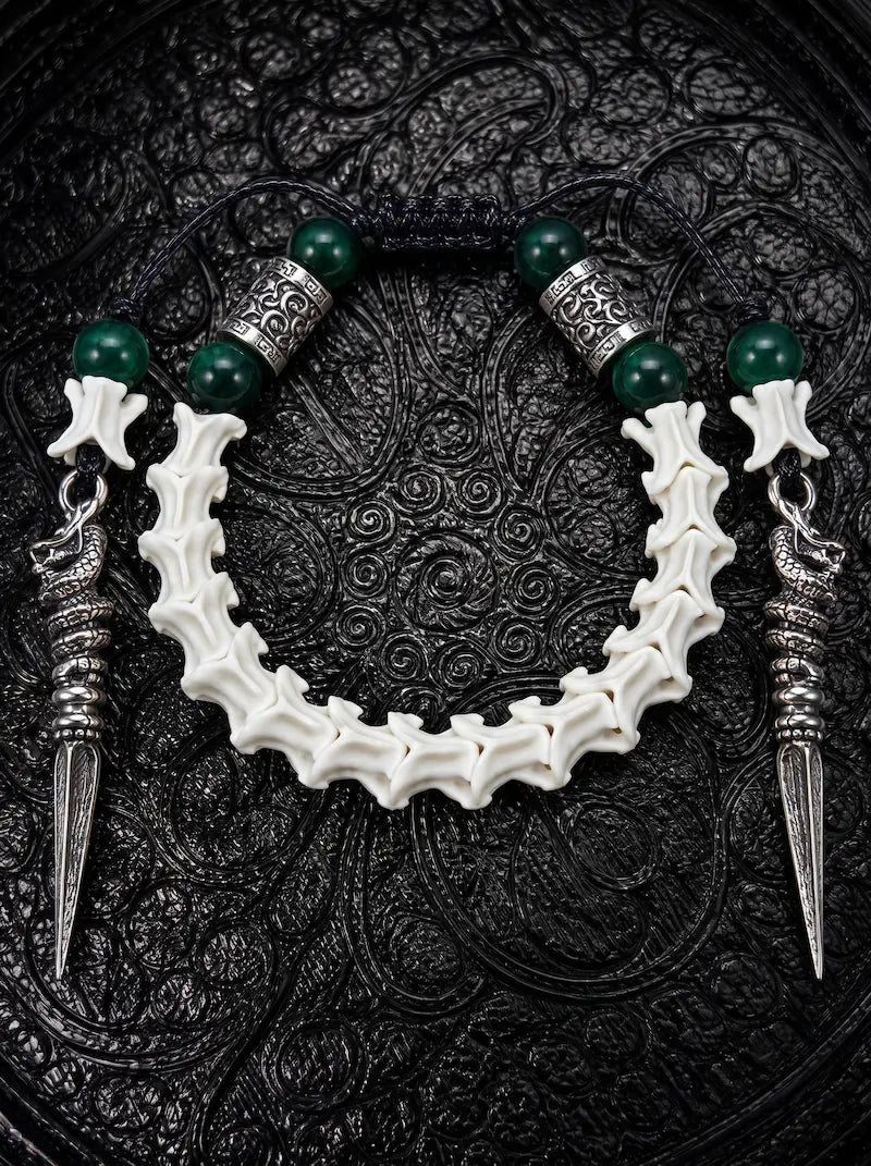 Viridian Wyrm snake bone bracelet with dark green beads, engraved silver-tone spacers and two long pointed drops