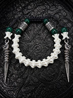 Viridian Wyrm snake bone bracelet with dark green beads, engraved silver-tone spacers and two long pointed drops