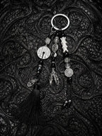 Yin Talisman Snake Bone Keychain, black tasseled keychain with pale snake bone, metal coin charms and ring clasp
