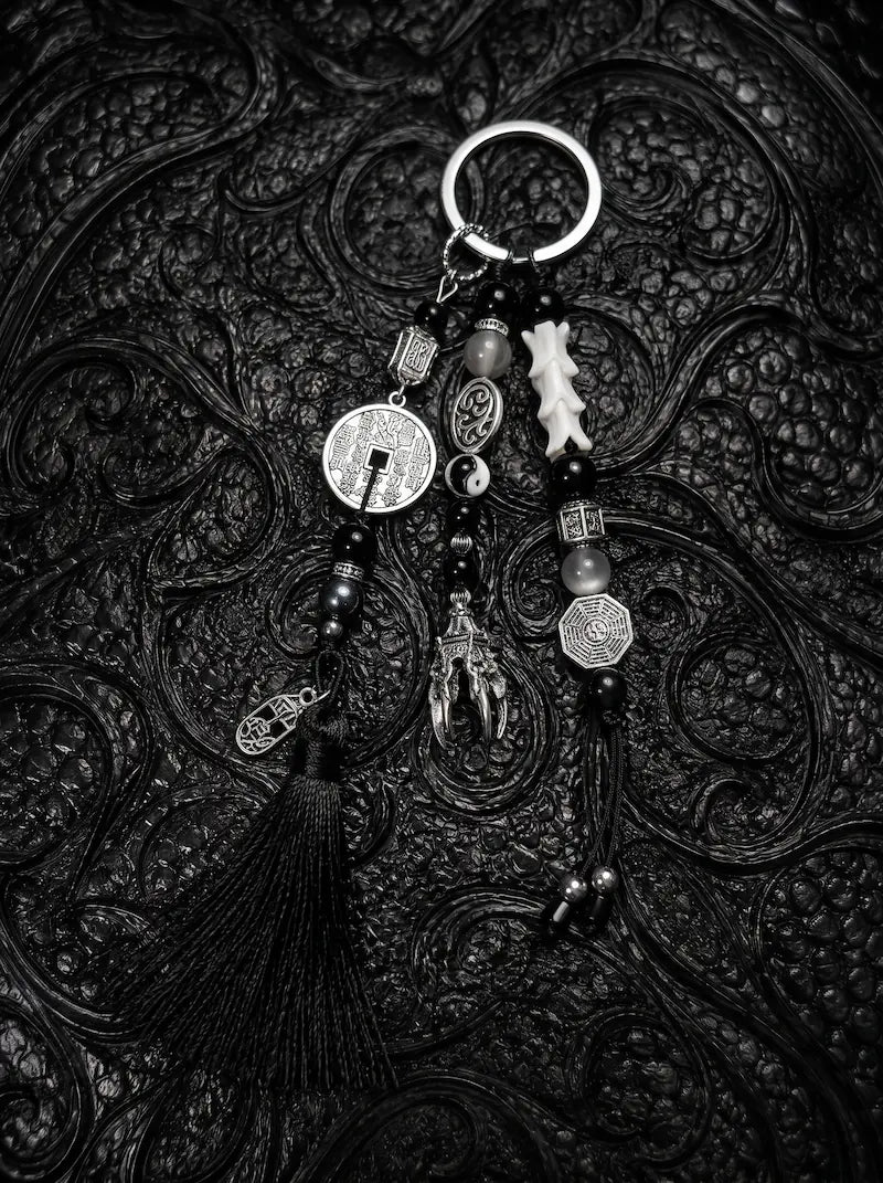 Yin Talisman Snake Bone Keychain, black tasseled keychain with pale snake bone, metal coin charms and ring clasp